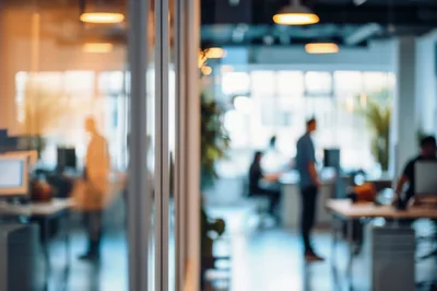 Blurred Office Interior With Employees Working In Open Space