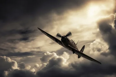 Vintage Supermarine Spitfire Flying Through Dramatic Storm Clouds