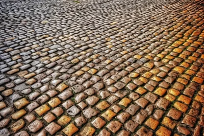 Textured Cobblestone Street Surface With Warm Lighting