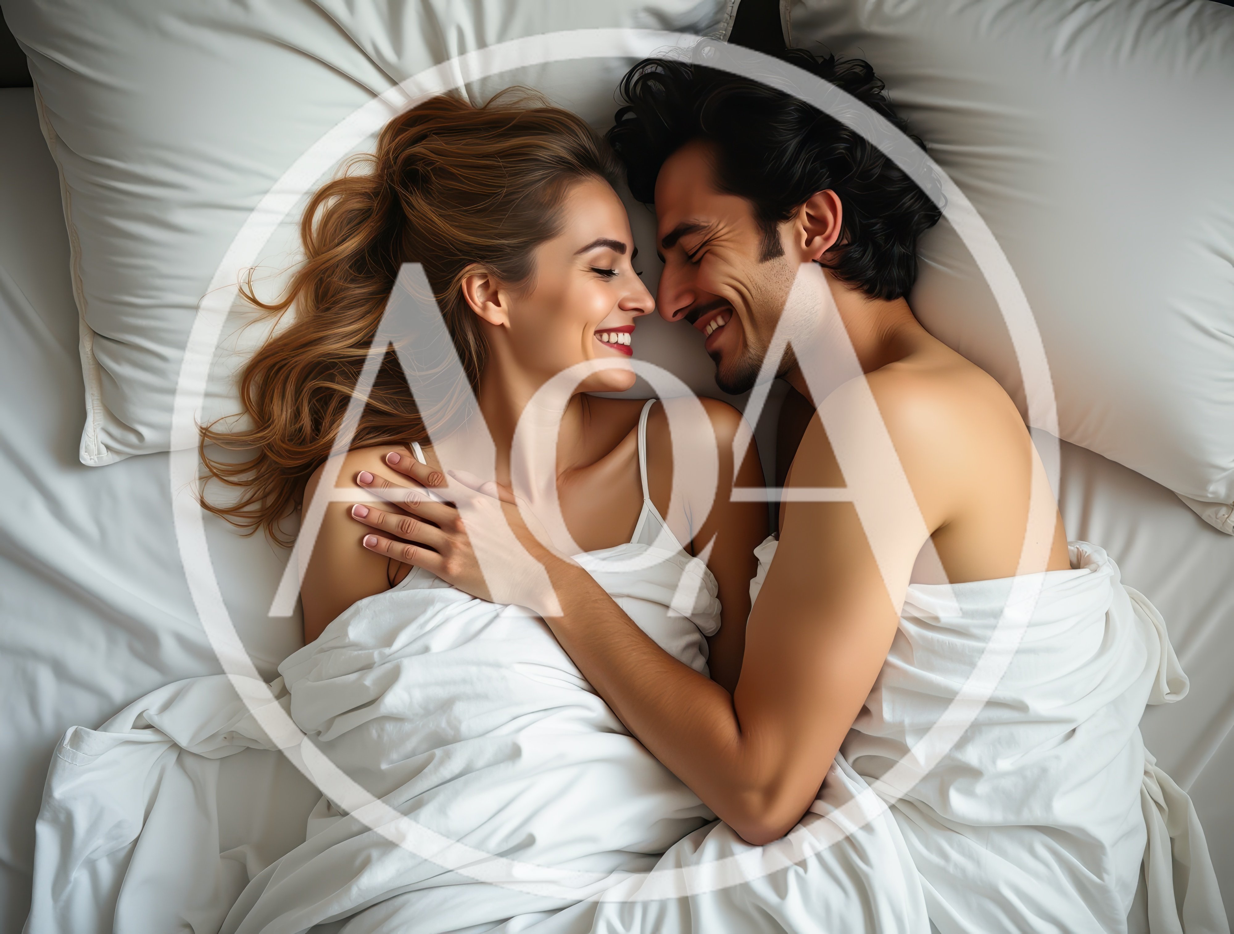Happy Couple Cuddling Together In Bed
