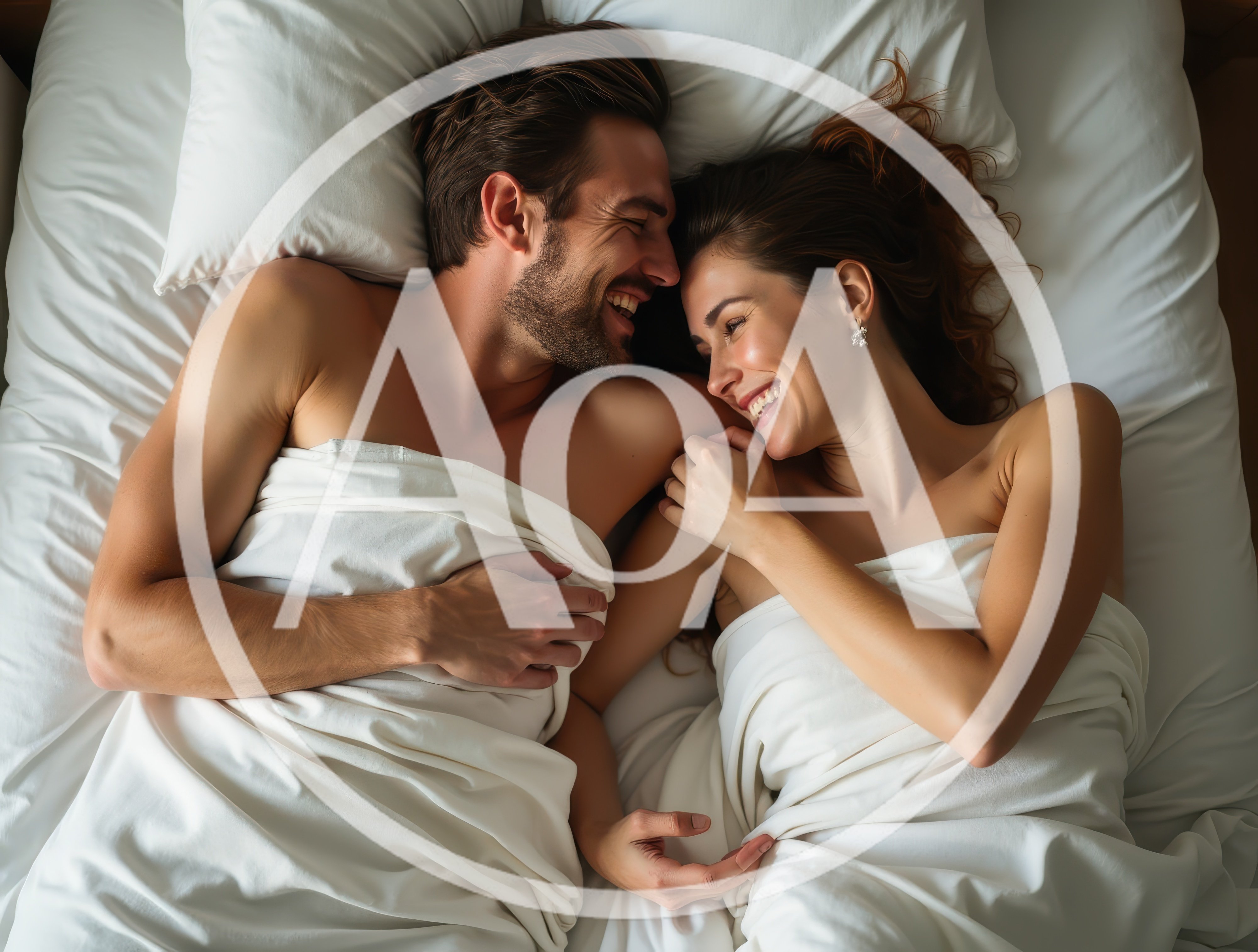 Happy Couple Laughing Together In Bed