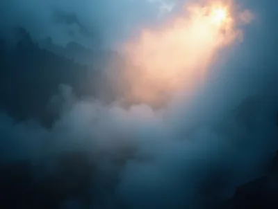 Sunlight Piercing Through Dense Mountain Fog