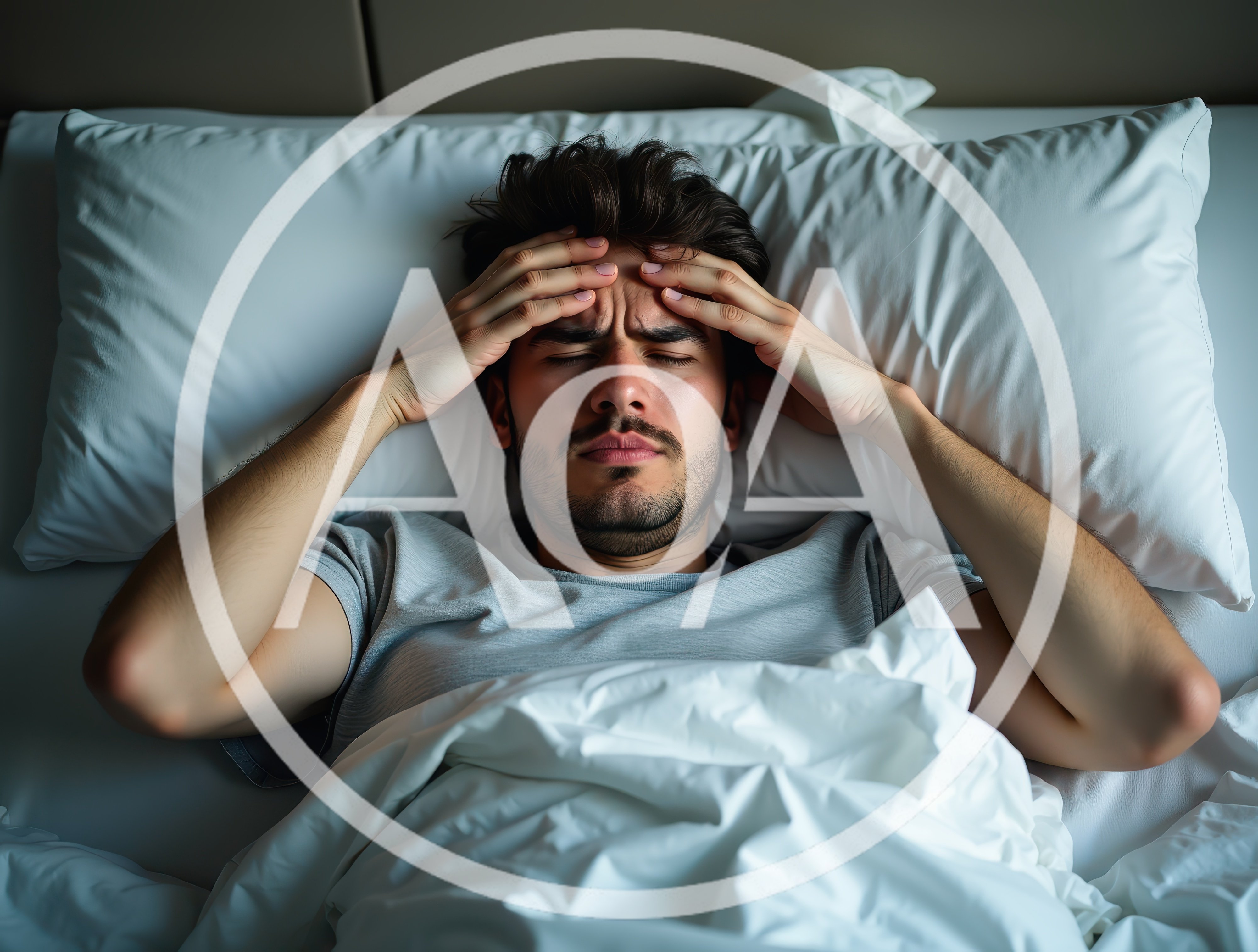 Young Man Suffering From A Severe Headache In Bed