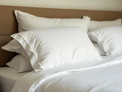 Close Up Of White Bed Pillows On A Bed