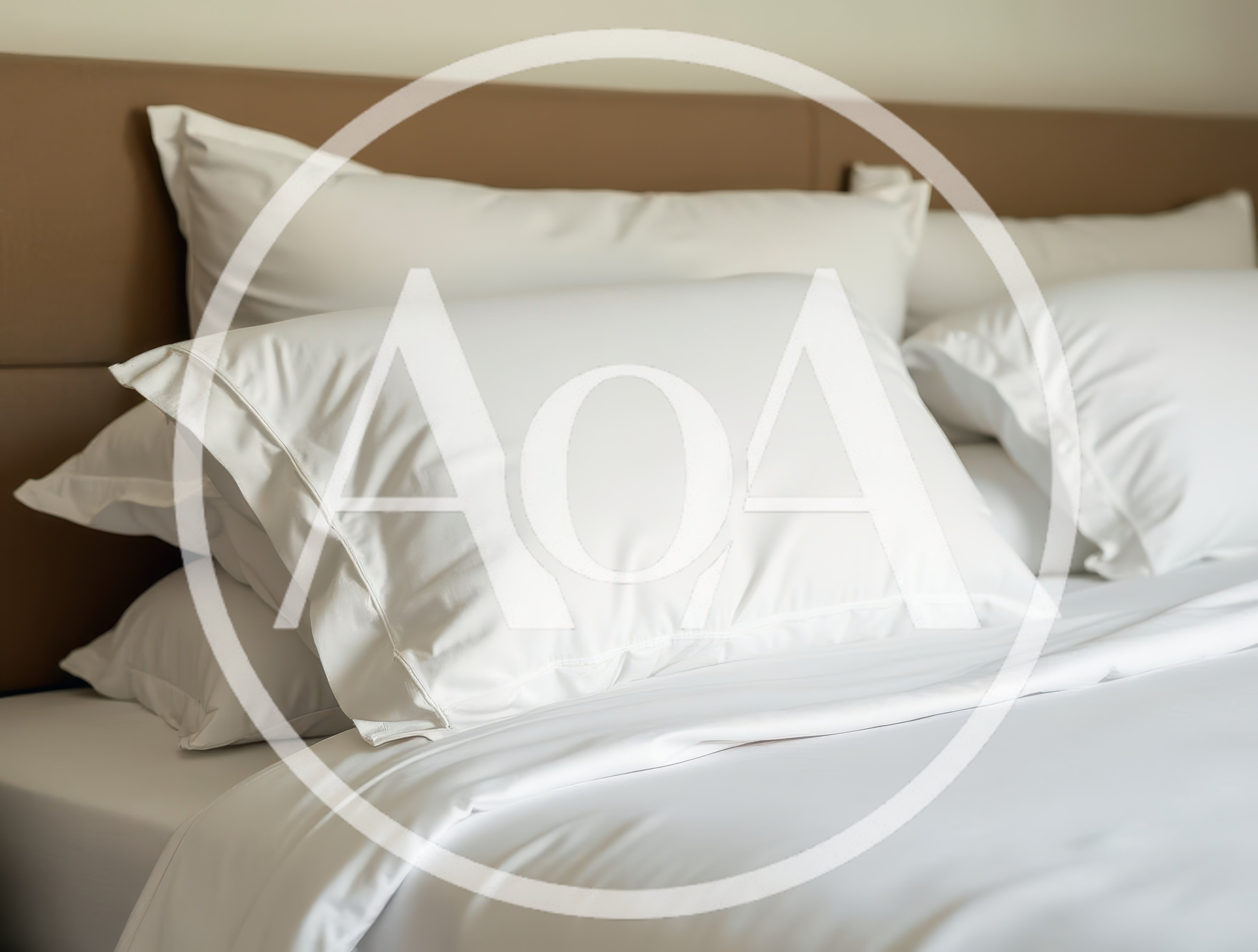 Close Up Of White Bed Pillows On A Bed