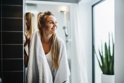Young Woman Drying Hair With Towel In Bathroom