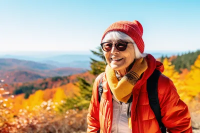 Senior Woman Hiking In Autumn Mountains
