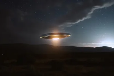 Glowing Unidentified Flying Object Hovering Over Desert Landscape