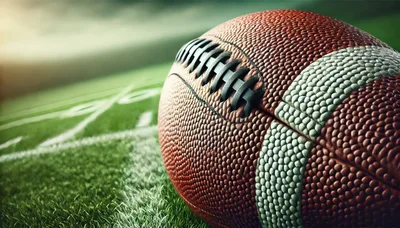 American Football Resting On A Professional Stadium Field