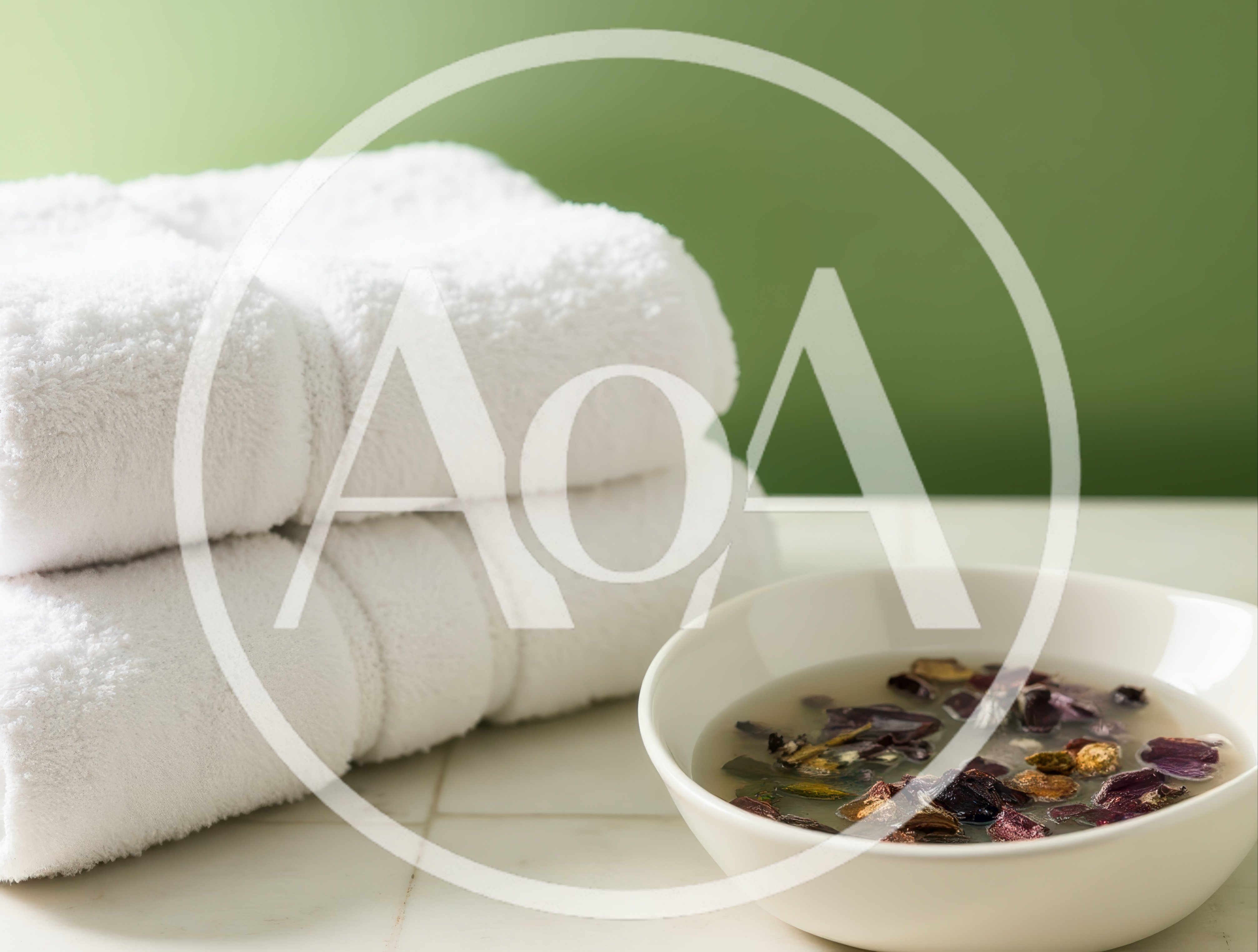 Spa Setting With White Towels And Floral Water Bowl