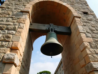 Large Bronze Bell Hanging In Stone Archway