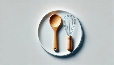 Wooden Spoon and Whisk on White Plate