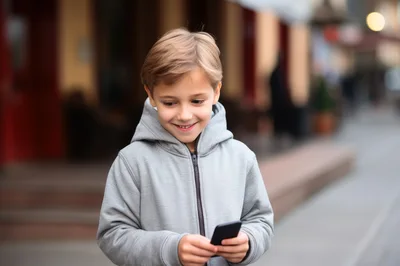 Young Boy Using Smartphone Outdoors