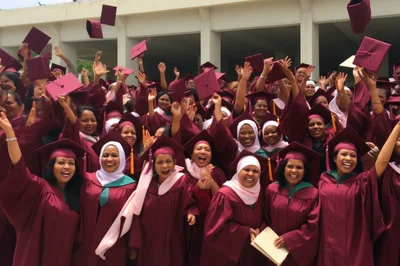 Group Of Graduates Celebrating With Caps In The Air