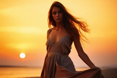 Young Woman Walking On Beach At Golden Hour