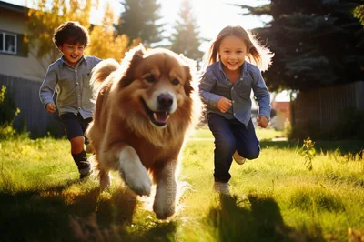 Two Children Running With Their Dog In A Park