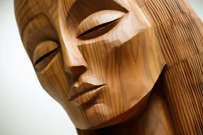 Close Up Of A Carved Wooden Human Face Sculpture