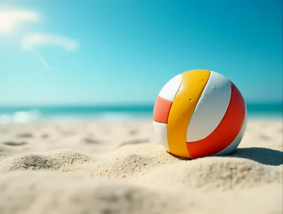 Volleyball Resting On Sandy Beach Under Clear Blue Sky