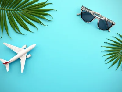 Travel Concept with Airplane Model and Sunglasses