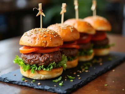 Four Gourmet Beef Sliders on a Slate Serving Board