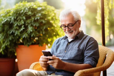 Senior Man Using Smartphone Outdoors