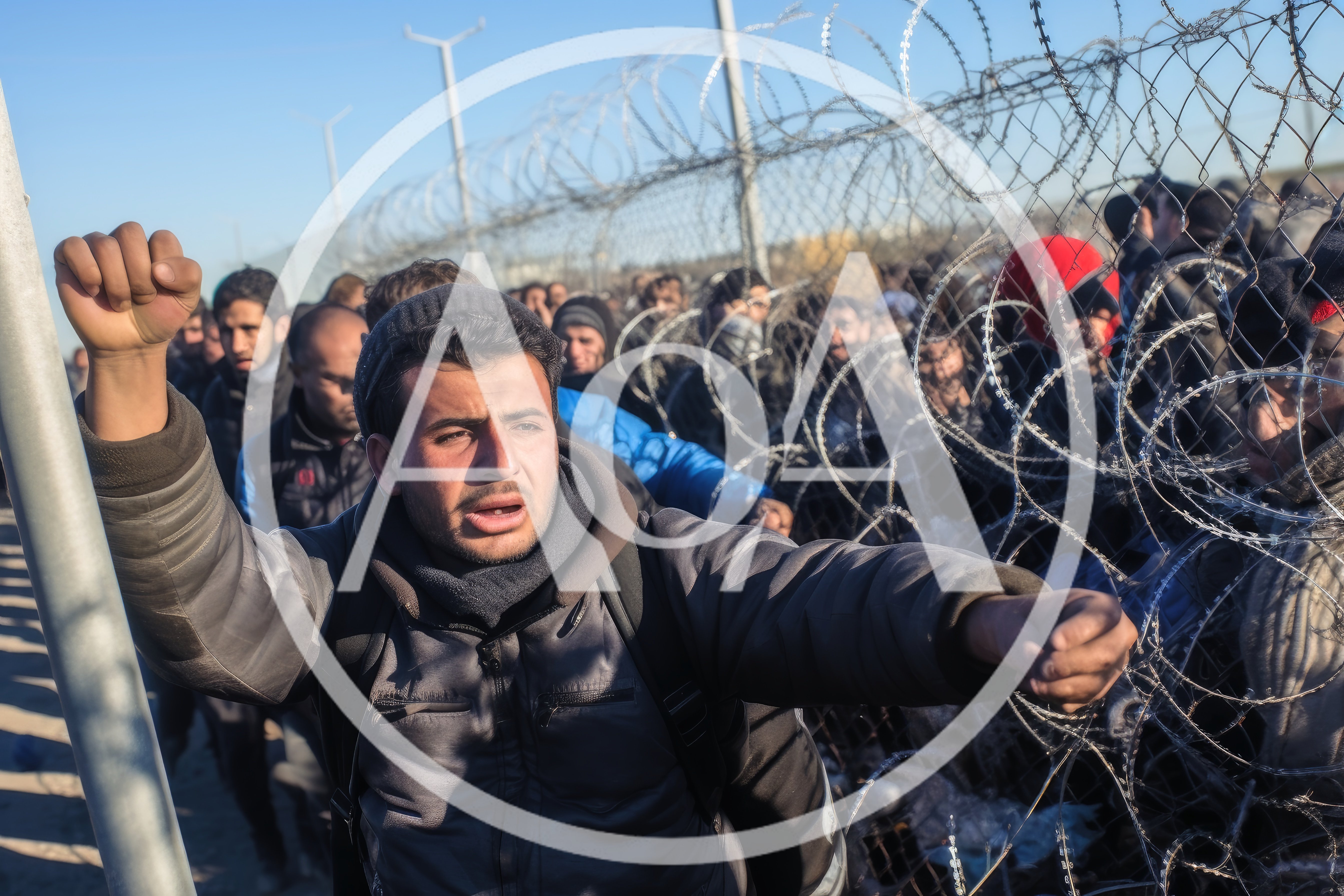 Migrants Protesting At Border Fence With Barbed Wire
