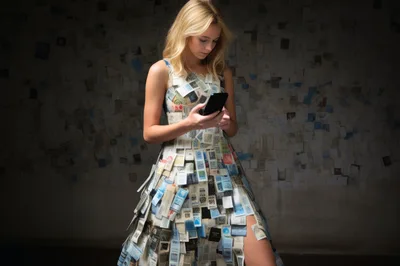 Young Woman Wearing A Dress Made Of Paper Documents