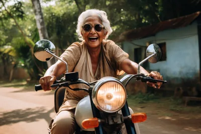 Joyful Elderly Woman Riding A Vintage Motorcycle
