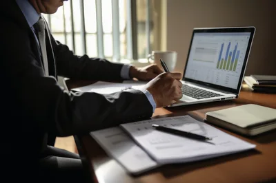 Professional Businessman Analyzing Financial Data On Laptop