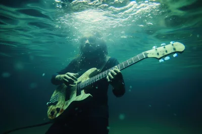 Man Playing Electric Guitar Underwater