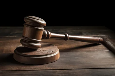 Wooden Judge Gavel Resting On A Sounding Block