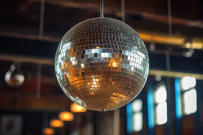 Large Reflective Disco Ball Hanging In A Dimly Lit Venue