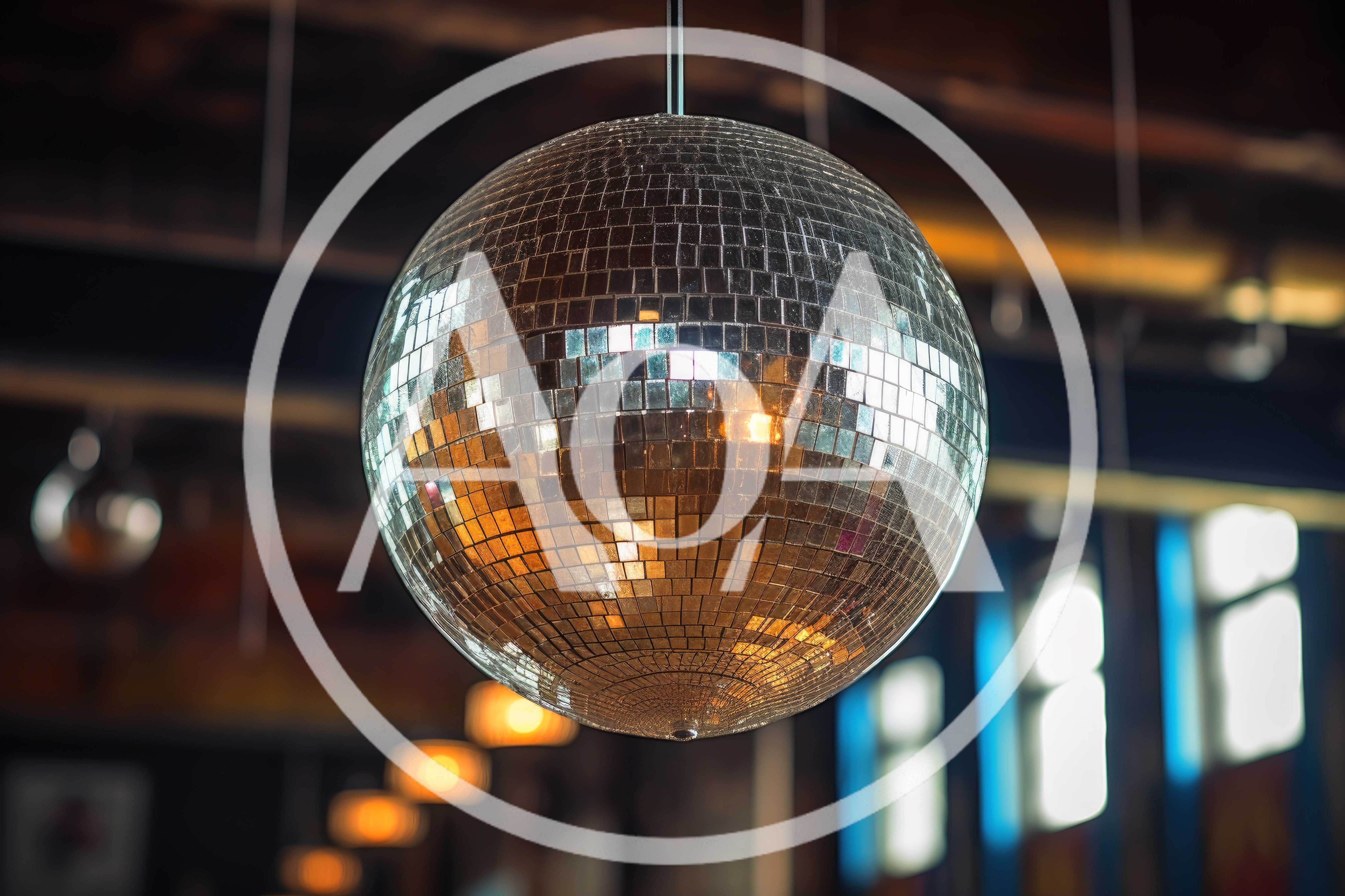 Large Reflective Disco Ball Hanging In A Dimly Lit Venue