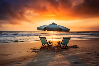 Two Beach Chairs Under Umbrella At Sunset