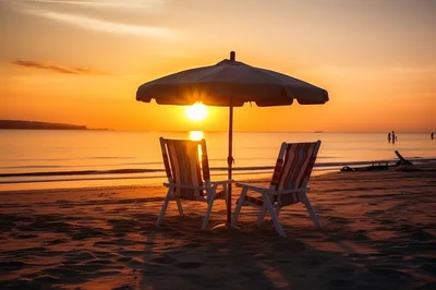 Two Beach Chairs Under Umbrella At Sunset