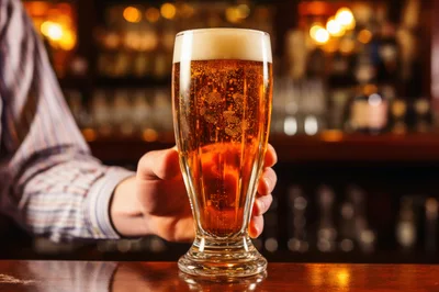 Bartender Serving A Glass Of Cold Beer