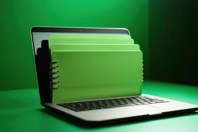 Green Notebooks Emerging From An Open Laptop Screen