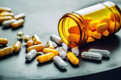 Pills Spilled From An Amber Prescription Bottle