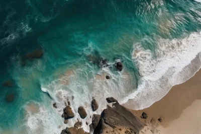 Aerial View Of Turquoise Ocean Waves Crashing On Beach
