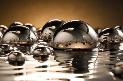 Liquid Mercury Spheres Reflecting Golden Light