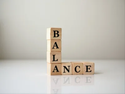 Wooden Blocks Spelling Balance On A Reflective Surface