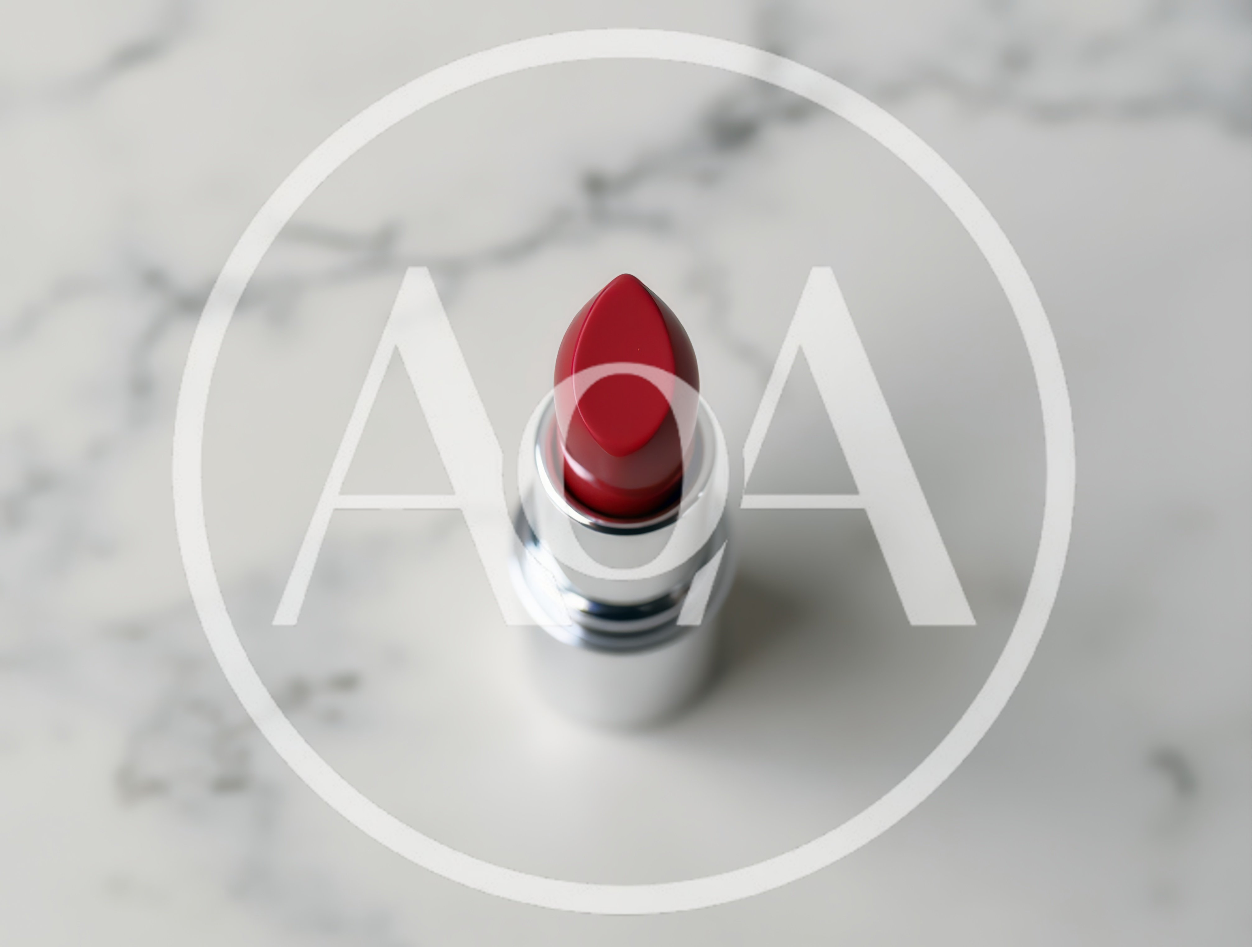 Red Lipstick Tube Standing On White Marble Surface