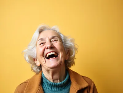 Happy Elderly Woman Laughing Against Yellow Background