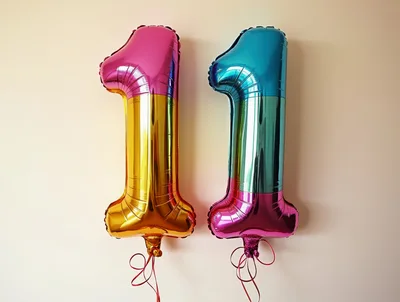 Two Colorful Number One Foil Balloons