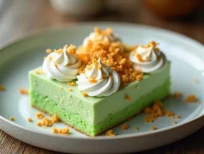 Slice Of Green Pistachio Cheesecake With Whipped Cream