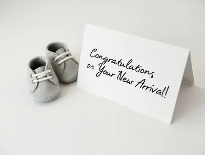 Baby Shoes Next To A Congratulations Card
