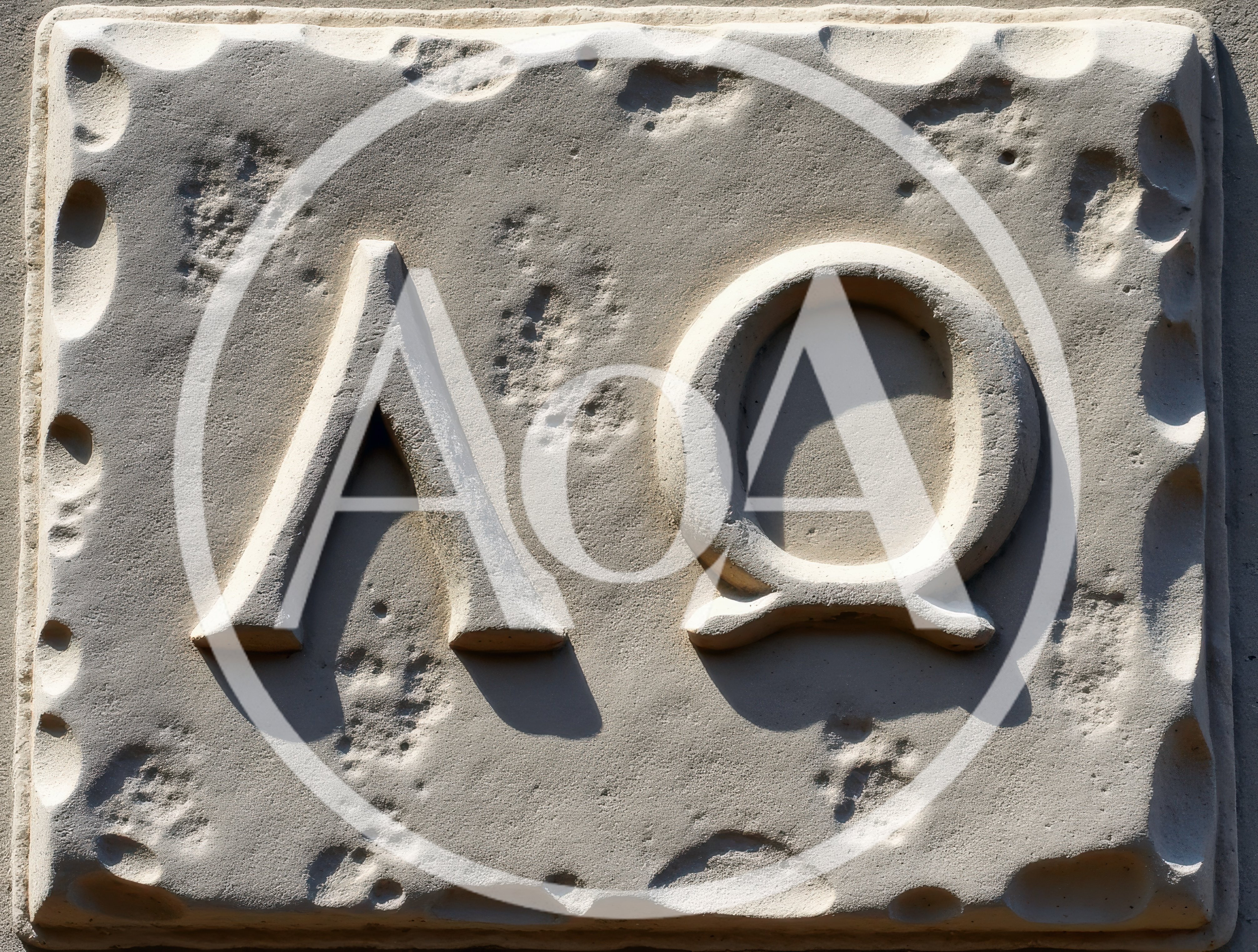 Stone Carving Of Greek Letters Lambda And Omega