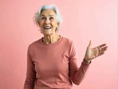 Senior Woman Gesturing With Hand Against Pink Background
