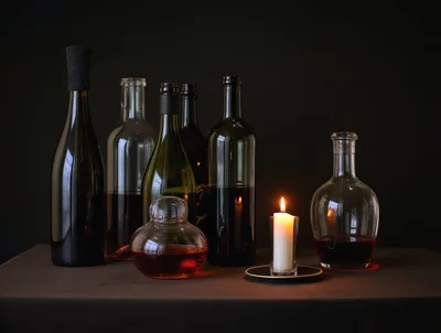 Still Life With Wine Bottles And Lit Candle