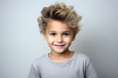 Portrait Of A Smiling Young Boy With Curly Hair